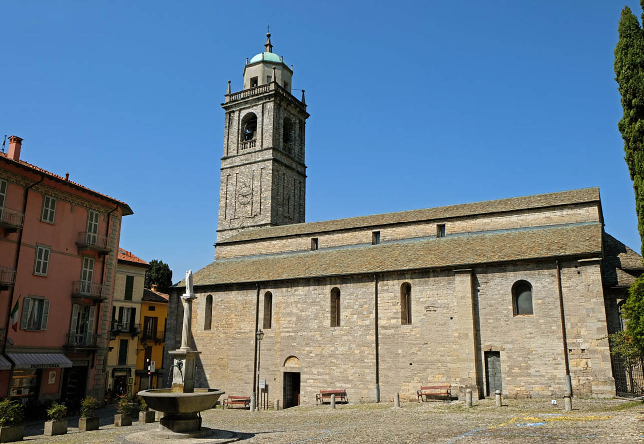 Die malerische Szene fängt die Essenz der Altstadt von Bellagio ein, mit ihrer alten Kirche und dem blauen Himmel als Hintergrund