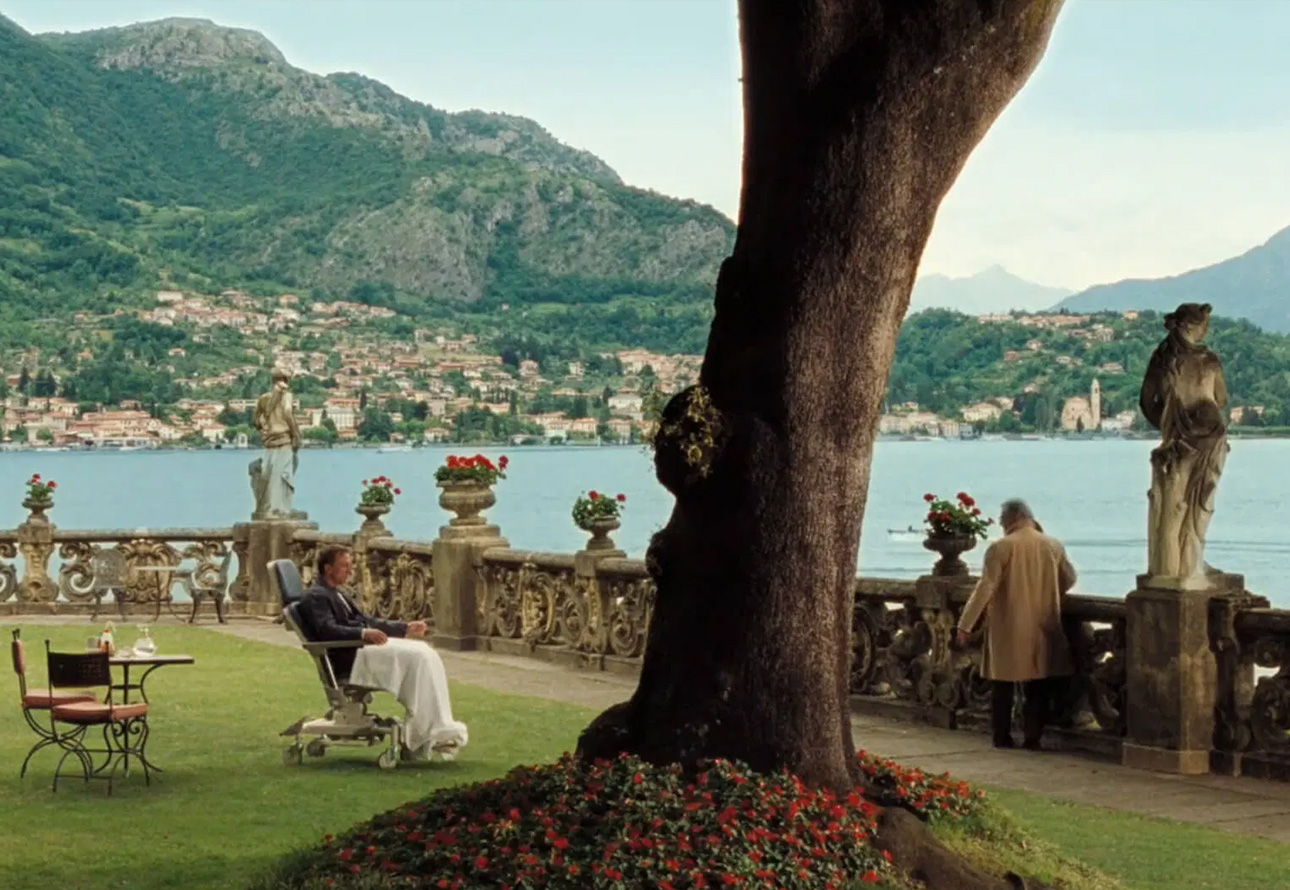 Daniel Craig sitting in a wheelchair looking at Lake Como in Casino Royale movie scene