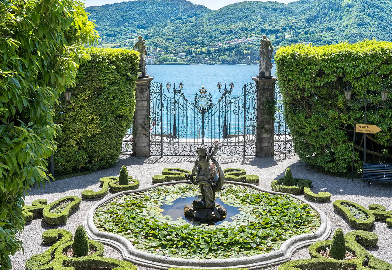 a central fountain and a statue in a beautiful gardens of Villa Carlotta